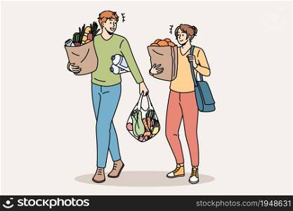 Shopping and buying fresh food concept. Young smiling couple man and woman cartoon characters walking carrying fresh food after going to grocery store vector illustration. Shopping and buying fresh food concept.
