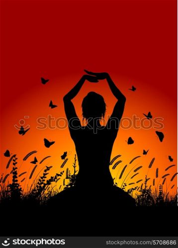 Silhouette of a female in a yoga pose against a sunset sky with butterflies flying around