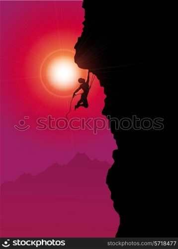 Silhouette of an extreme rock climber climbing a mountain