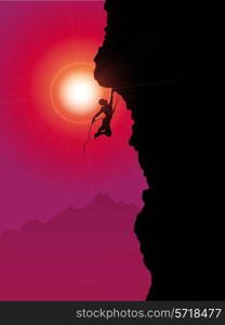 Silhouette of an extreme rock climber climbing a mountain