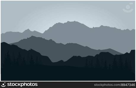 silhouette of mountains with trees against the background of the setting sun in blue tones