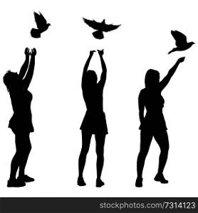 Silhouette of three girls let a dove in the sky.. Silhouette of three girls let a dove in the sky