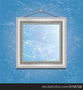 Silver frame on the wall with blue wallpaper