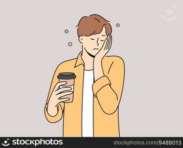 Sleepy man with disposable cup of coffee feels exhausted and lacks strength due to lack of sleep. Guy sleeps on go and tries to cheer up with takeaway coffee with high content of caffeine and taurine. Sleepy man with disposable cup of coffee feels exhausted and lacks strength due to lack of sleep