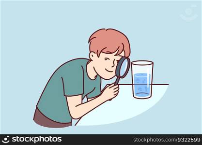 Small boy examines water in glass through magnifying glass, studying chemical composition liquid or looking for microbes. Teenage child curiously studies water, wanting to work in chemical laboratory. Small boy examines water in glass through magnifying glass, studying chemical composition liquid 