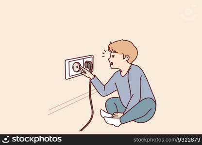 Small boy sticks fingers into socket, playing with electrical equipment and risking electric shock. Preschool child with curiosity pulls fingers to electrical socket and needs attention of parents. Small boy sticks fingers into socket, playing with electrical equipment and risking electric shock
