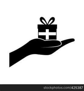 Small gift box in a hand black simple icon. Small gift box in a hand icon