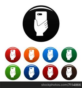 Smartphone in hand icons set 9 color vector isolated on white for any design. Smartphone in hand icons set color