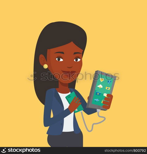 Smiling african-american woman recharging her smartphone with mobile phone portable battery. Young woman holding a mobile phone and battery power bank. Vector flat design illustration. Square layout.. Woman reharging smartphone from portable battery.