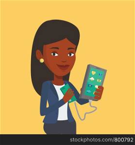 Smiling african-american woman recharging her smartphone with mobile phone portable battery. Young woman holding a mobile phone and battery power bank. Vector flat design illustration. Square layout.. Woman reharging smartphone from portable battery.