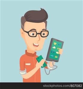 Smiling caucasian man recharging his smartphone with a mobile phone portable battery. Happy man holding a mobile phone and a battery power bank. Vector flat design illustration. Square layout.. Man reharging smartphone from portable battery.