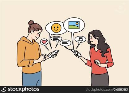 Smiling girlfriends using cellphones communicating online on social media. Happy girls chat text on internet on smartphones, send share messages on devices. Communication. Vector illustration. . Smiling girls communicate online on smartphones 