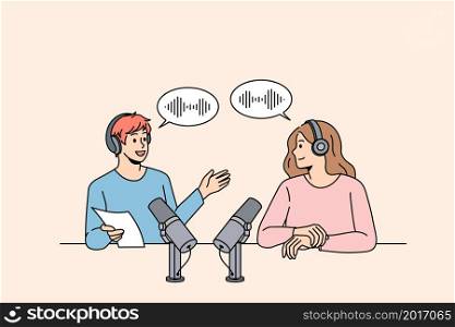 Smiling man radio host talk with guest in studio. Happy male presenter speak with woman, have communication record podcast together. Entertainment industry. Flat vector illustration. . Smiling radio host have communication with female guest