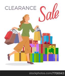 Smiling woman is standing with shopping bags. Big present boxes on the background. Holliday sale and clearance concept. Young beautiful happy girl picks up packages with clothes. Sale advertising. Smiling woman is standing with shopping bags. Big present boxes. Holliday sale and clearance concept