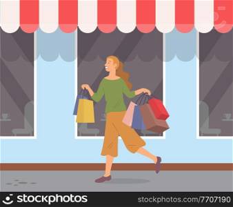 Smiling woman with shopping bags walking in the city. Young beautiful happy girl returns home with multi-colored packages with clothes. Female character on the background of a boutique window. Woman with shopping bags walking in the city. Young girl with purchases on background of a boutique