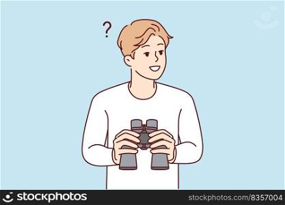 Smiling young man feeling confused holding binoculars in hands. Happy male frustrated looking in binocular finding solution. Exploration and discovery. . Smiling man holding spyglass 