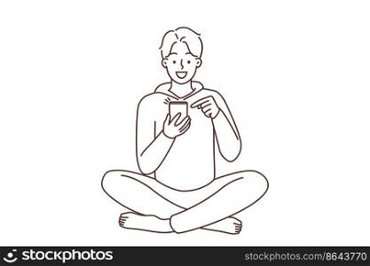 Smiling young man sit on floor using modern smartphone. Happy guy with cellphone browse internet or chat online on social media. Vector illustration. . Smiling man using cellphone 