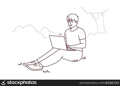 Smiling young man sit on ground in park working on laptop. Happy male freelance type on computer outdoors. Remote job or education. Vector illustration.. Smiling man sit in park work on laptop