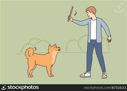 Smiling young man training with dog in park. Happy male with wood in hands teach commands with cute puppy outdoors. Vector illustration. . Smiling man training with dog in park 
