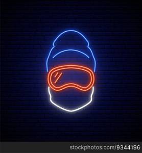 Snowboarder neon sign. Man in ski goggles, mask and winter hat. Winter sports icon. Stock vector illustration.