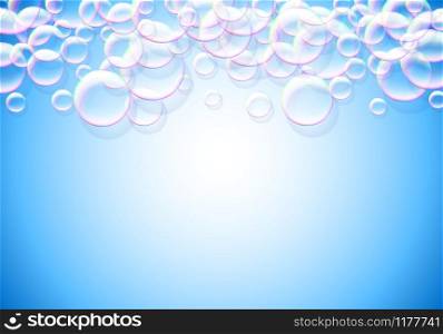 Soap bubbles blue background with rainbow colored airy foam