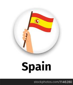 Spain flag in hand, round icon with shadow isolated on white. Human hand holding flag, vector illustration. Spain flag in hand, round icon