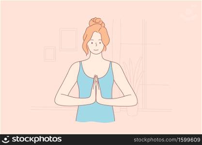 Sport, yoga, recreation, coronavirus, quarantine concept. Namaste or let peace be with you. Young happy smiling woman girl holding hands together in pray meditating practicing asanas at home lockdown.. Sport, yoga, recreation, coronavirus, quarantine, meditation concept