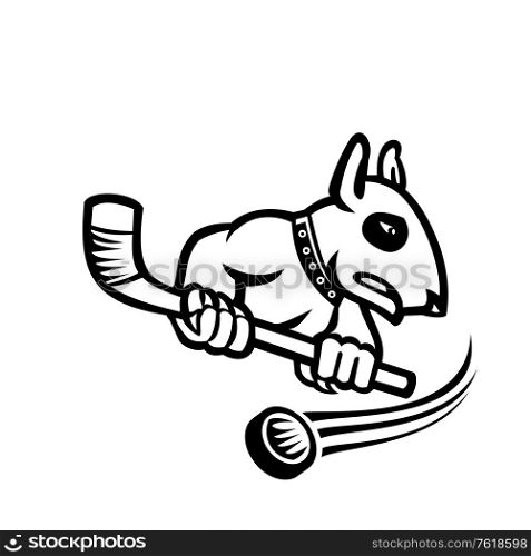 Sports mascot black and white illustration of a bull terrier or wedge head holding an ice hockey stick with puck at back viewed from side on isolated background in retro style.. Bull Terrier With Ice Hockey Stick Mascot Black and White