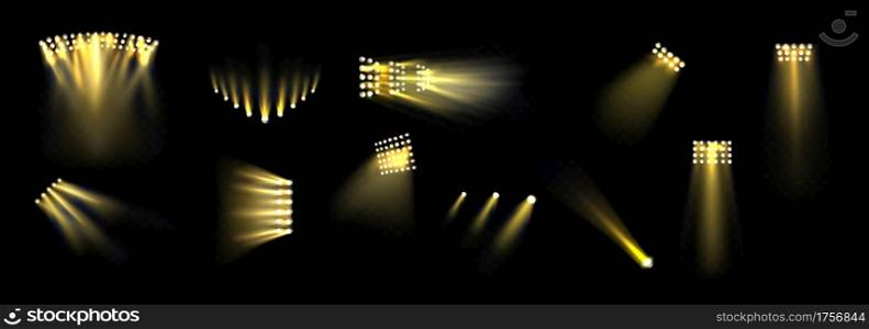 Stage spotlights with shine gold beams isolated on black background. Vector realistic set of stadium projectors with yellow light rays. Illumination equipment for concert, show or party. Stage spotlights set, light projectors for stadium