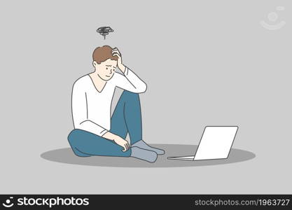 Stress and exhaustion at ideas concept. Young stressed man cartoon character sitting on floor near laptop and feeling frustrated and stuck with ideas vector illustration . Stress and exhaustion at ideas concept