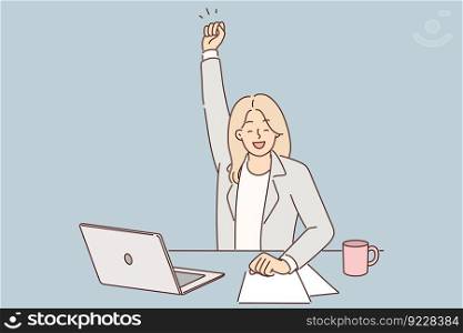 Successful woman manager celebrates victory and raises hand up sitting at table with laptop. Businesswoman rejoices at successful completion of project enjoying new achievement or signing contract. Successful woman manager celebrates victory and raises hand up sitting at table with laptop