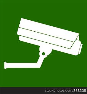 Surveillance camera icon white isolated on green background. Vector illustration. Surveillance camera icon green