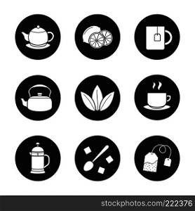 Tea icons set. Cutted lemon, steaming cup on plate, brewer, teapot, loose tea leaves, teabag, refined sugar cubes with spoon, kettle, mug. Vector white silhouettes illustrations in black circles. Tea icons set