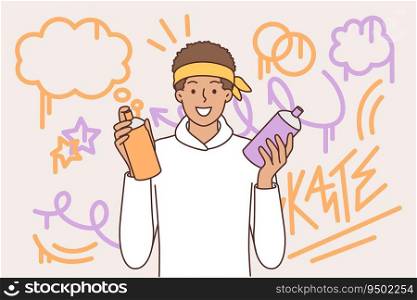 Teenager guy draws graffiti on wall, holds spray can of paint and smiling looks at camera. Ethnic teenage boy from street art subculture uses graffiti to showcase creativity or hobbies.. Teenager guy draws graffiti on wall, holds spray can of paint and smiling looks at camera