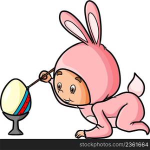 The boy with the rabbit costume is coloring the easter egg