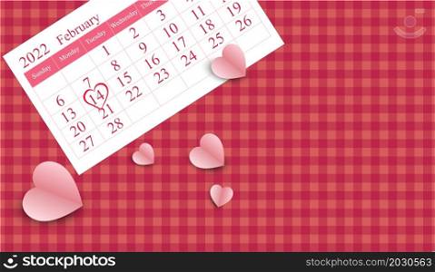 The calendars. with heart shape marked Valentine&rsquo;s Day. on 14th February 2022 and Heart pink paper cut, on pink ?plaid fabric background. with copy space for text. for the banner design elements.