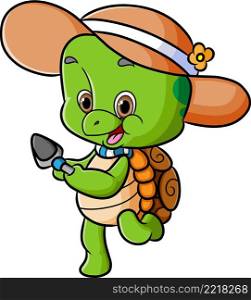 The cute turtle is wearing the beach hat and holding the shovel