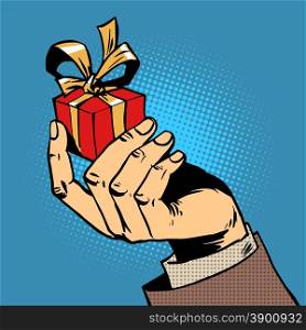 The gift in his hand a small box pop art comics retro style Halftone. Imitation of old illustrations.. gift in his hand a small box pop art comics retro style Halftone