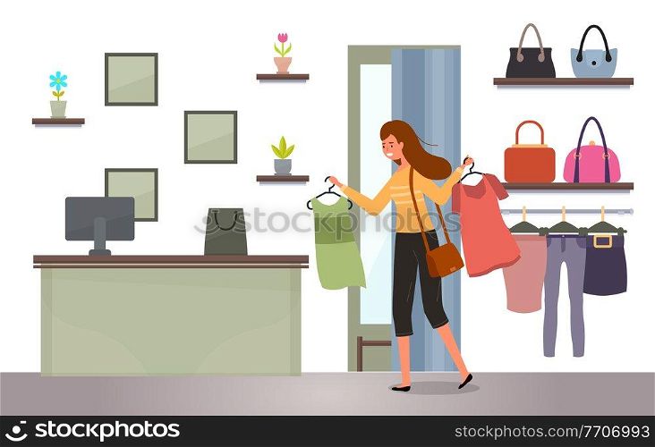 The girl with a hangers with t-shirts in her hands shopping. Buyer is selecting clothes in a store. Young beautiful fashion girl isolated on white background. Woman goes to the checkout with purchases. Girl with a hangers with t-shirts in her hands shopping. Woman goes to the checkout with purchases