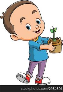 The happy boy is holding the plant on the pot