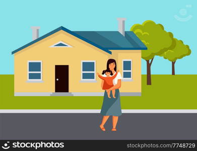 The mother stands with a small child in her arms. Parent and daughter are on the street at the house, natural landscape. The girl happily raises her hands. Mom is taking care of the baby uotdoor. The mother stands with a small child in her arms. Parent and daughter are on the street at the house