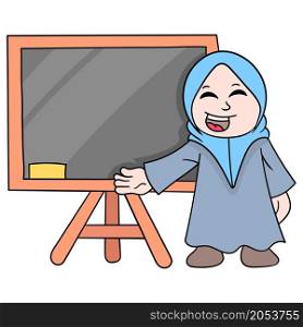 the teacher wearing a beautiful muslim hijab stands in front of the blackboard ready to explain the lesson
