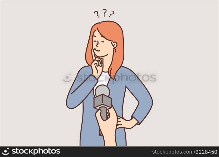 Thoughtful woman near microphone in hand of reporter interviewing passers-by and making question among residents of city. TV journalist interviewing girl while filming report on important issues.. Thoughtful woman near microphone in hand of reporter interviewing passers-by and making question