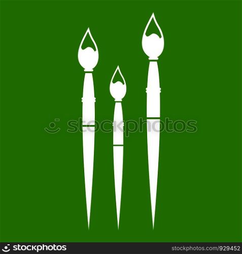 Three brushes for painting icon white isolated on green background. Vector illustration. Three brushes for painting icon green