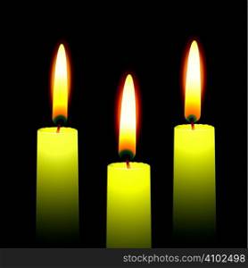 Three burning candles with yellow wax and outer glow