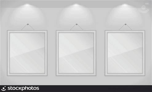 Three white wooden frames on gray wall