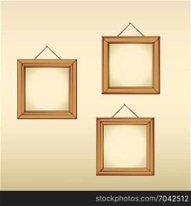 Three wooden empty frames hanged on a wall