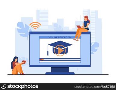 Tiny women learning online on computer. Screen, laptop, hat flat vector illustration. E-learning and education concept for banner, website design or landing web page