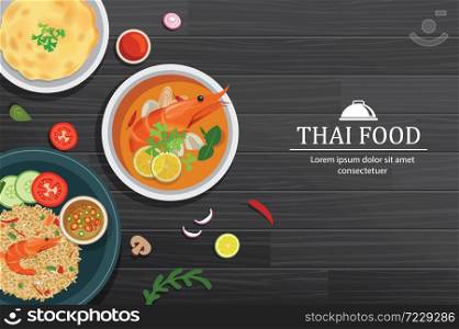 Tom yum kung in the bowl on black wood table top view. Thailand set food background.