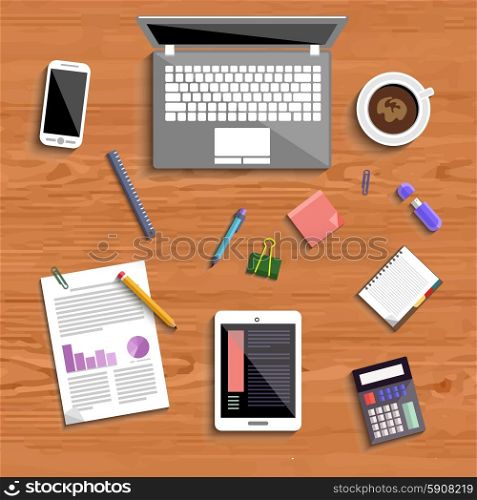 Top view of business people workplace with laptop, digital tablet, smartphone and different office elements on wood table